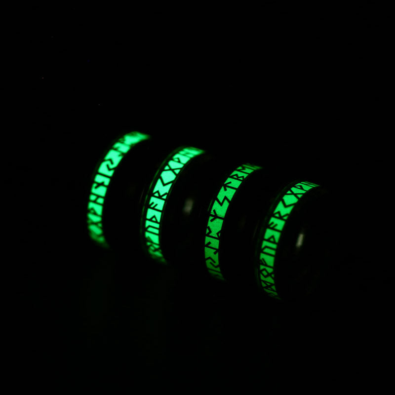 Two green glow-in-the-dark rings on a black background