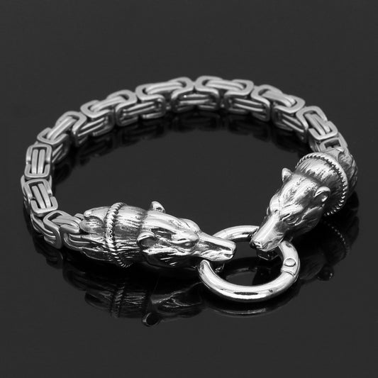 Silver bracelet with ram heads on a black background