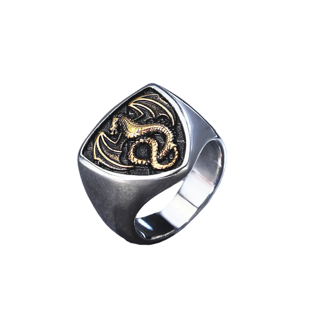 Silver ring with gold dragon design on a white background