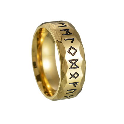 Gold ring with engraved symbols on a white background