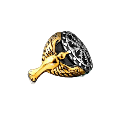 Gold and silver ring with intricate design on a black background