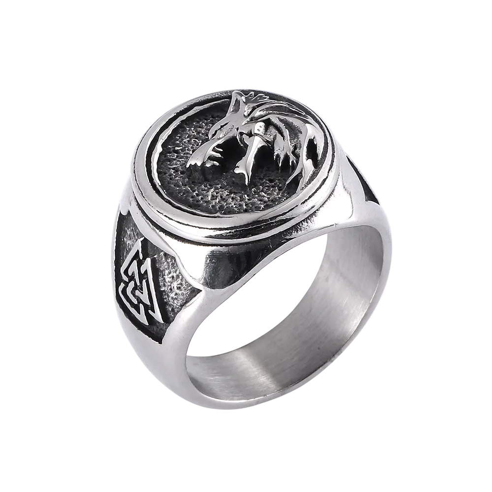 Silver ring with wolf design on a white background