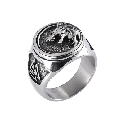 Silver ring with wolf design on a white background
