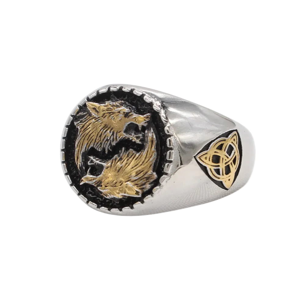 A silver-toned signet ring featuring two gold-toned wolves facing each other on a black inlay, with a gold Celtic knot symbol on the band, shown against a plain white background.