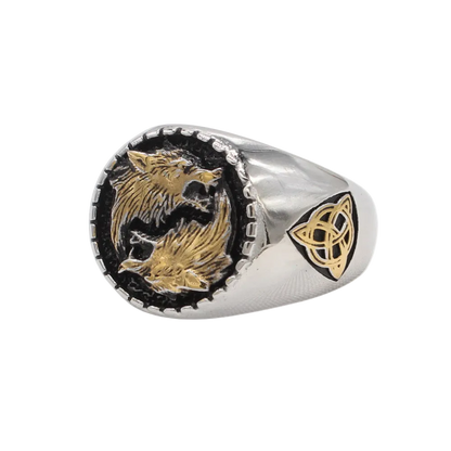 A silver-toned signet ring featuring two gold-toned wolves facing each other on a black inlay, with a gold Celtic knot symbol on the band, shown against a plain white background.