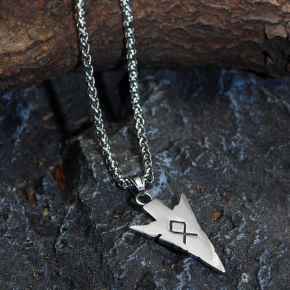 Silver necklace with a pendant on a textured stone surface